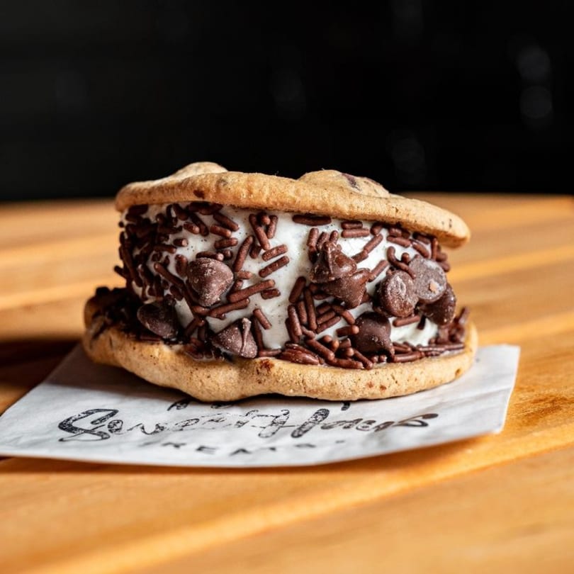 Sweethaus Treats ice cream sandwich with chocolate chip cookies, vanilla ice cream, and sprinkles.